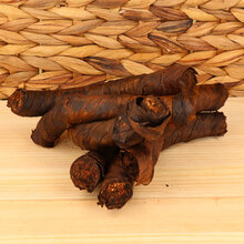 A small pile of twist tobacco on a wodden base with a wicker background