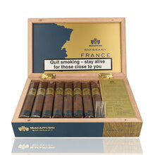 Open box of 16 Macanudo Emissary France Robusto cigars with branded presentation, information card and individually cellophaned cigars displayed inside.