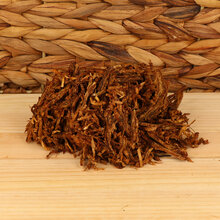 Close-up of Samuel Gawith Full Virginia Ready Rubbed loose pipe tobacco showing dark brown broken-flake pieces and strands of pressed Virginia leaf.
